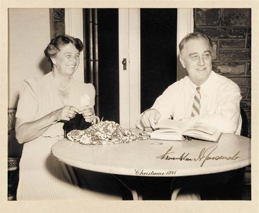 ROOSEVELT, Franklin D. Portrait of the President and First Lady, by the Associated Press, at Hyde Park, Christmas 1941. 8 x 9/3/4 in., a black and white photograph, unframed, matted. A well-known image of FDR and Eleanor, with carefully ink caption "Christmas 1941," depicting them in a relaxed mood, seated at a table, Eleanor knitting and the President reading a book. SIGNED IN INK BY THE PRESIDENT: "Franklin D. Roosevelt" in the white area of the table. An image widely circulated in the weeks following the shock of America's sudden entry into World War II.
