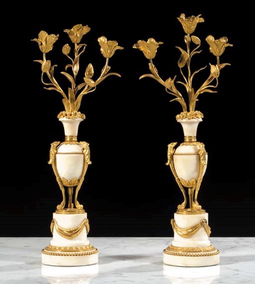 A pair of Louis XVI white marble and ormolu three-light candelabras