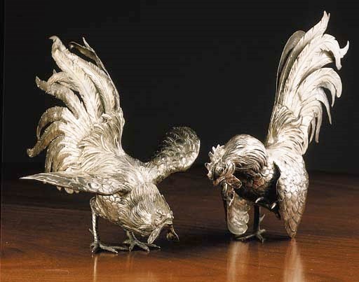 A pair of silver cockerels