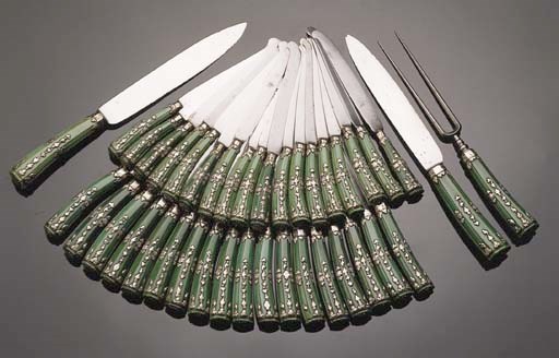 Eighteen table knives, ten dessert knives, two meat knives and a meat fork with green coloured ivory handles