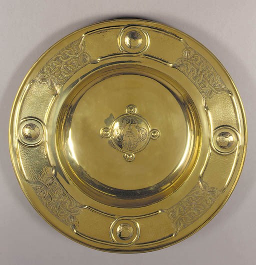 An Arts and Crafts brass hammered charger