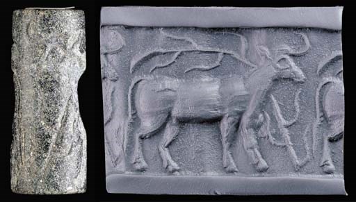 A LATE URUK/JEMDET NASR BLACK STONE CYLINDER SEAL