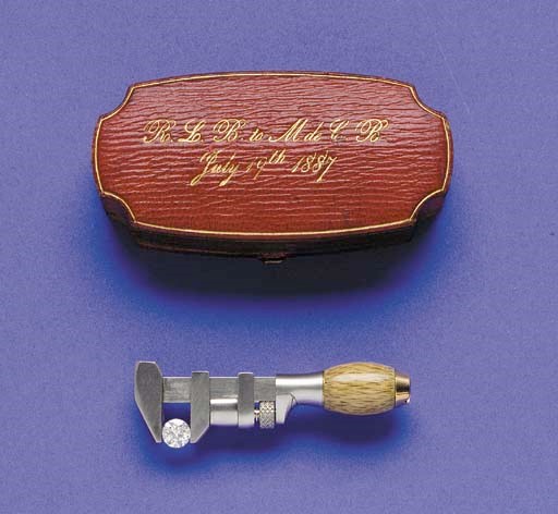 AN UNUSUAL GOLD AND SILVER, DIAMOND "MONKEY WRENCH" BROOCH IN PRESENTATION CASE, CIRCA 1887