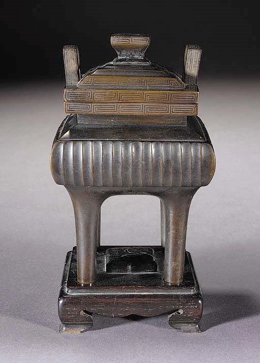 A bronze and silver inlaid censer and cover
19th Century