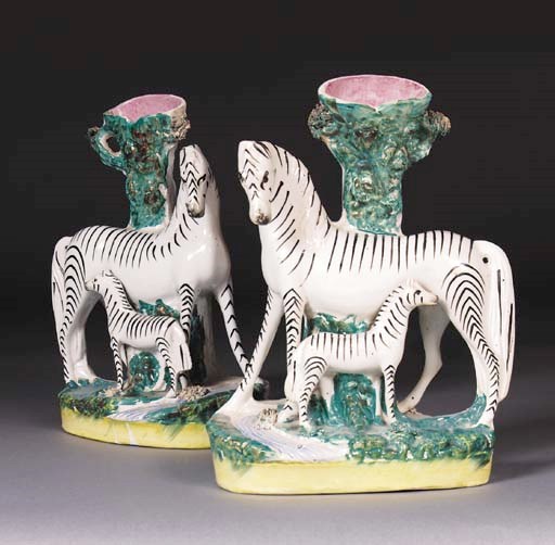 A pair of Staffordshire zebra spill vases