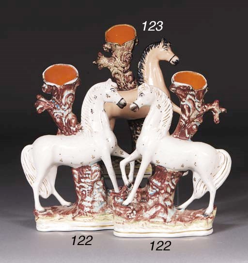 A pair of Staffordshire circus pony spill vases