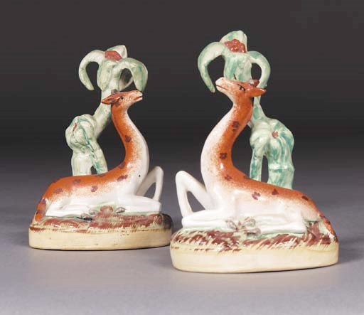 A pair of late Staffordshire models of giraffes