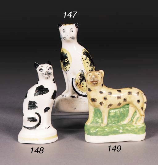 A Staffordshire model of a tortoiseshell cat