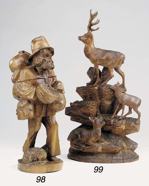 A Black Forest carved and stained pine model of deer amongst rockwork, late 19th or early 20th century