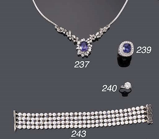AN 18K WHITE GOLD TANZANITE AND DIAMOND NECKLACE AND RING