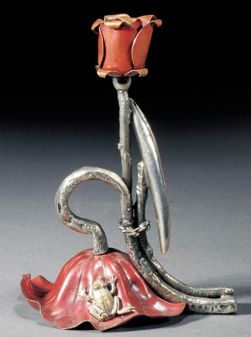 A patinated copper and white metal candle holder