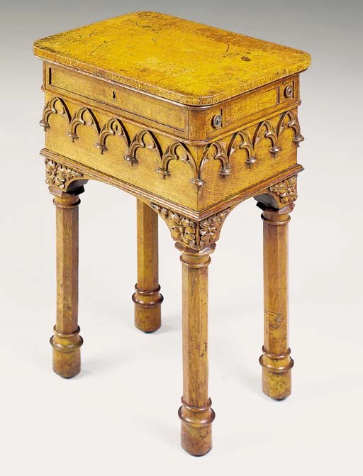 AN EARLY VICTORIAN OAK GOTHIC WRITING-TABLE