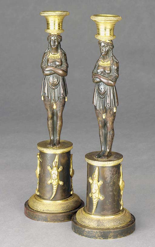 A PAIR OF REGENCY BRONZE AND ORMOLU CANDLESTICKS