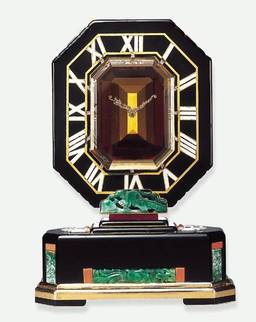 A HIGHLY IMPORTANT ART DECO JADE, CITRINE, CORAL AND ENAMEL "MYSTERY" CLOCK, BY CARTIER