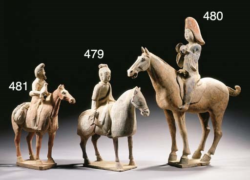 A painted red pottery figure of a female musician on horseback