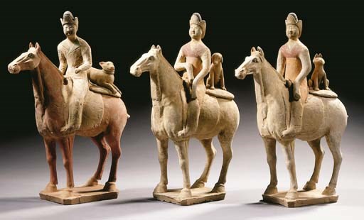 A group of four painted red pottery hunters on horseback
