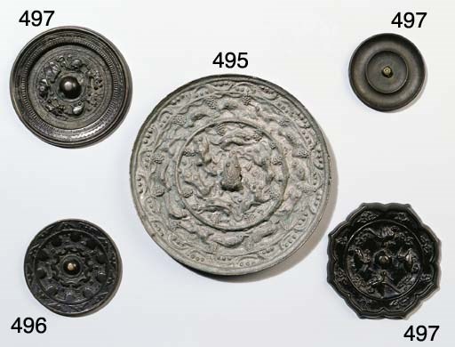 Four bronze circular mirrors