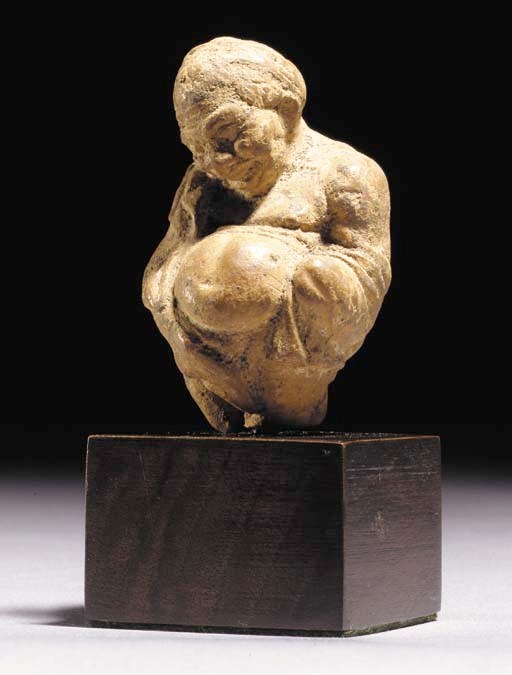 A GREEK TERRACOTTA FIGURE OF A MIDDLE COMEDY ACTOR