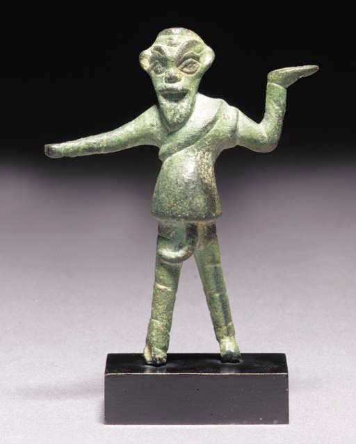 A GREEK BRONZE FIGURE OF A COMIC ACTOR IN THE ROLE OF A KITCHEN SLAVE