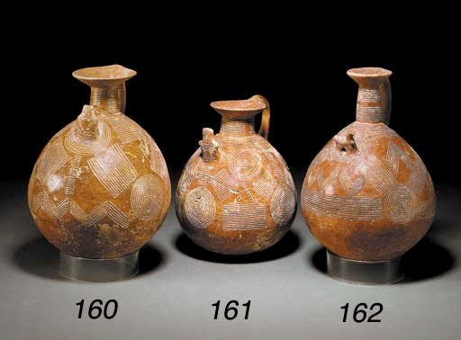 A CYPRIOT INCISED RED POLISHED WARE JUG WITH BIRD-SHAPED LUG