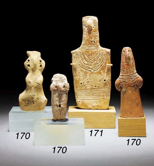 A CYPRIOT INCISED RED POLISHED WARE PLANK FIGURE