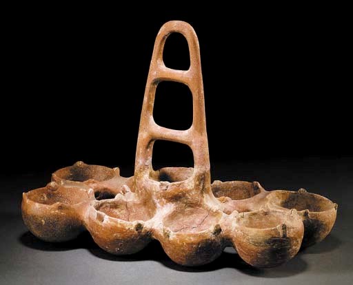 A CYPRIOT PLAIN RED POLISHED WARE NINE-BOWL VESSEL
