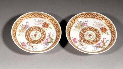A pair of famille rose, iron red and gilt saucers
19th century