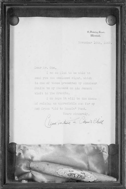 [CHURCHILL, Sir Winston Spencer (1874-1965) and Joseph STALIN (1879-1953)]. A 'Sovetskye' cigar, approximately 150 x 20mm, attached by threads to a cushion and mounted with a letter signed by Clementine Churchill to 'Mr Coe', Downing Street, 16 November 1942, 'I am so glad to be able to send you the enclosed cigar, which is one of those presented by Monsieur Stalin to my Husband on his recent visit to the Kremlin. I do hope it will be the means of raising an appreciable sum for my Red Cross "Aid to Russia" Fund', one page, 4°, framed and glazed.
