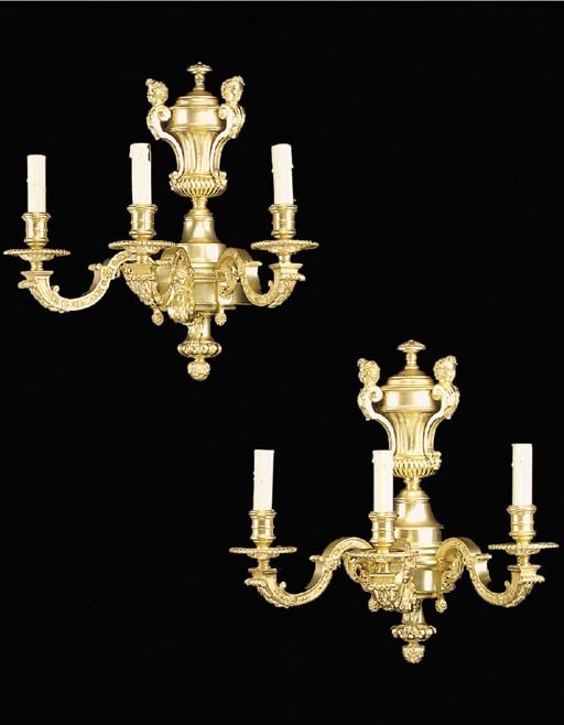 A pair of Regence style gilt bronze three light wall appliques, 20th century