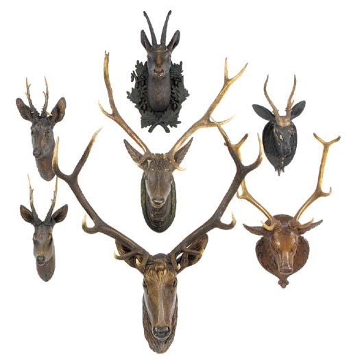 A collection of seven carved wood deer heads, late 19th and early 20th century