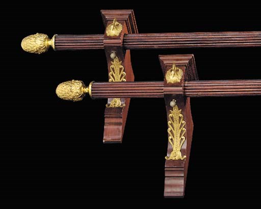 A pair of gilt bronze mounted stained wood curtain poles, 20th century