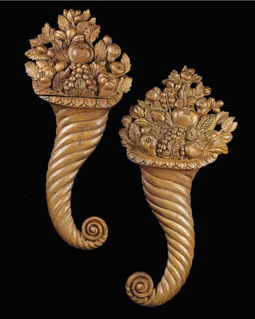 A pair of carved limewood cornucopia wall plaques, late 19th or early 20th century