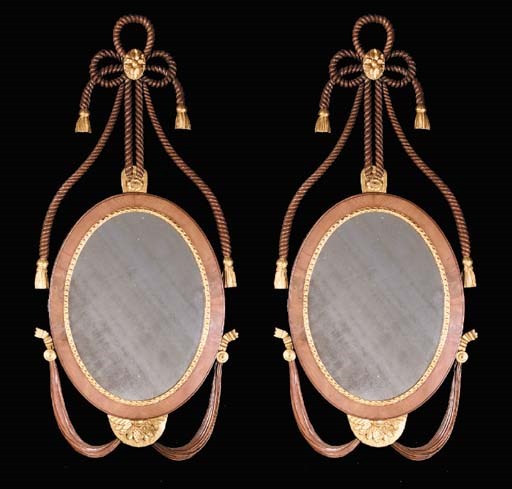 A PAIR OF DANISH MAHOGANY AND PARCEL GILT OVAL MIRRORS, 19TH CENTURY AND LATER