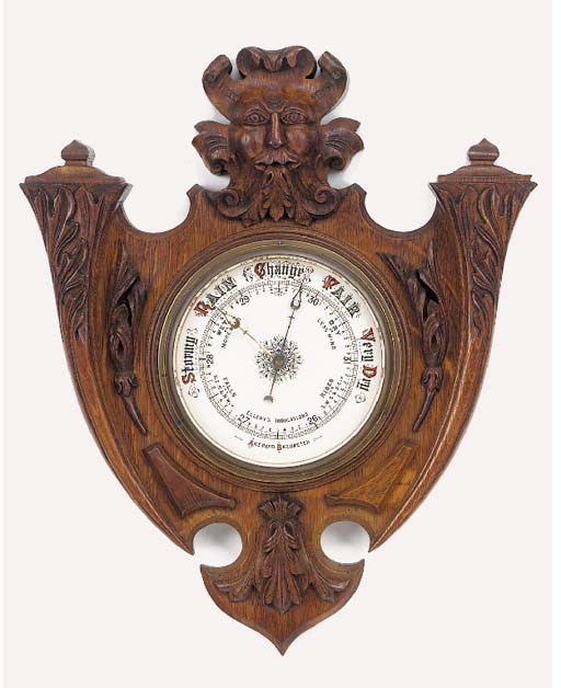 A Victorian carved oak aneroid barometer, circa 1880