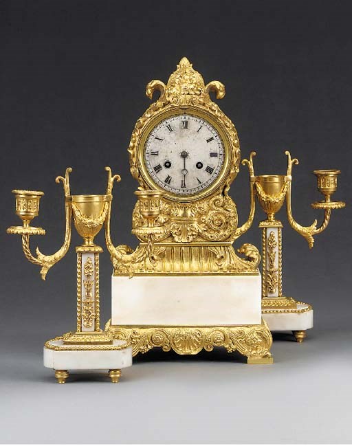 A Louis Philippe gilt-bronze and white marble striking mantel clock and ganiture, mid 19th century