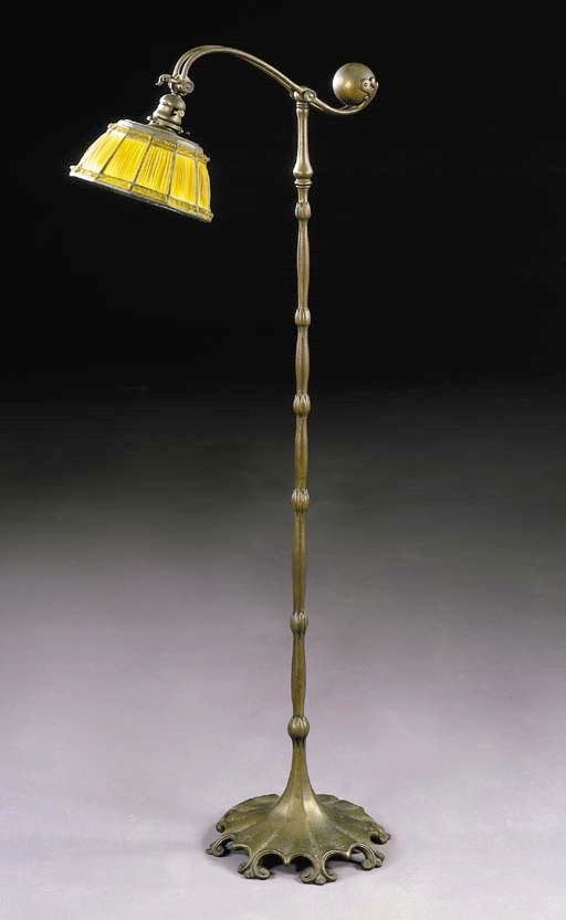 A 'LINENFOLD' LEADED GLASS AND GILT-BRONZE COUNTER BALANCE FLOOR LAMP