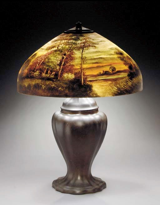 A SCENIC REVERSE-PAINTED GLASS AND PATINATED-METAL TABLE LAMP