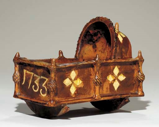 A STAFFORDSHIRE REDWARE CRADLE