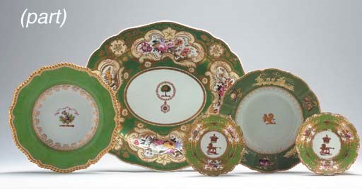 FIVE ENGLISH GREEN-GROUND ARMORIAL AND CRESTED PLATES AND PLATTERS