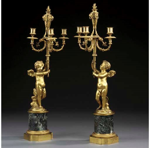 A pair of ormolu three light candelabra