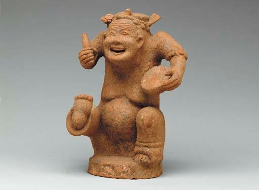 A Small Red Pottery Figure of a Drummer,