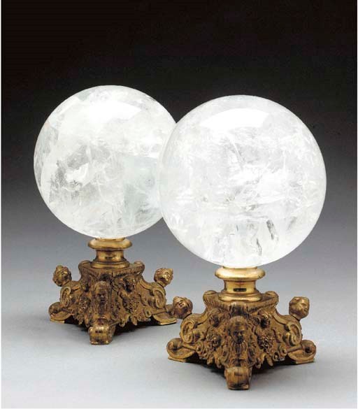 A PAIR OF ROCK CRYSTAL SPHERES ON ORMOLU BASES,