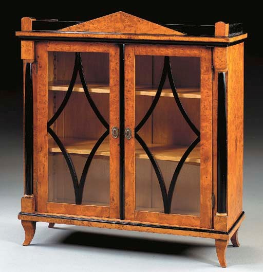 A NORTH EUROPEAN BIEDERMEIER BURR ELM AND PARCEL-EBONIZED VITRINE,