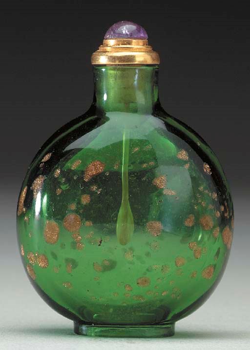 A GOLD-SPLASHED GREEN GLASS BOTTLE
