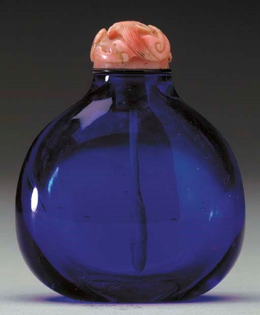 A SAPPHIRE-BLUE GLASS BOTTLE