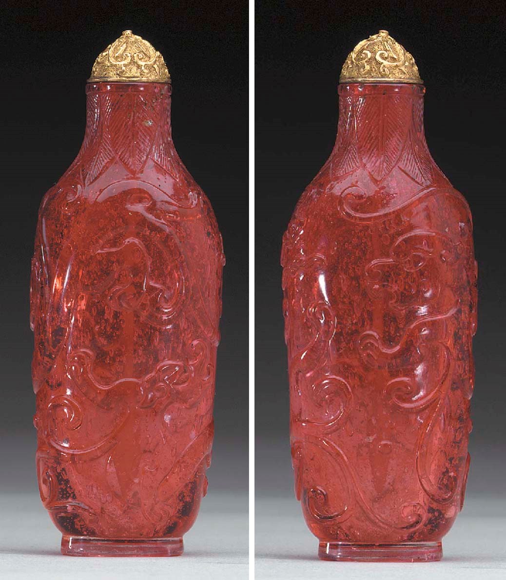 A RARE CARVED RED GLASS BOTTLE