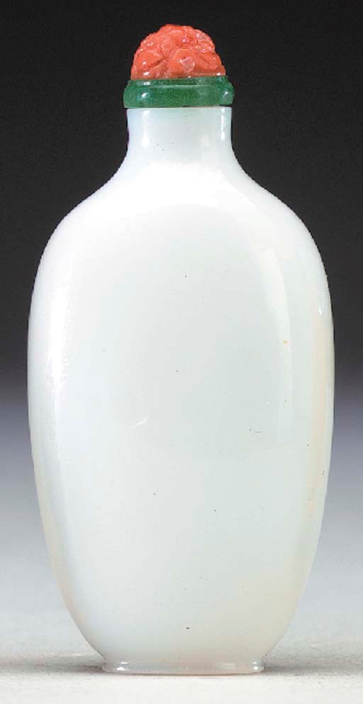A SMALL WHITE GLASS BOTTLE