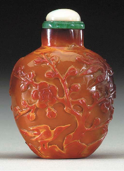 AN UNUSUAL CARVED REALGAR GLASS BOTTLE