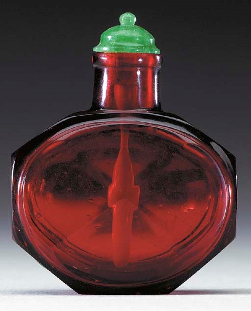 A FINE RUBY-RED FACETED GLASS BOTTLE