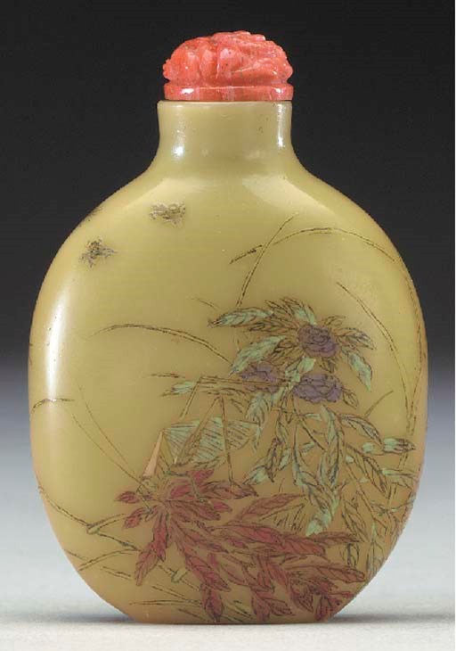 AN ENAMELED GLASS BOTTLE